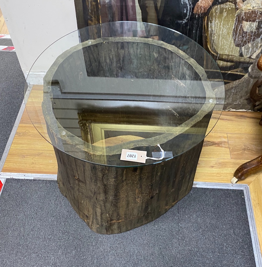 A tree trunk section glass top occasional table, diameter 66cm, height 62cm